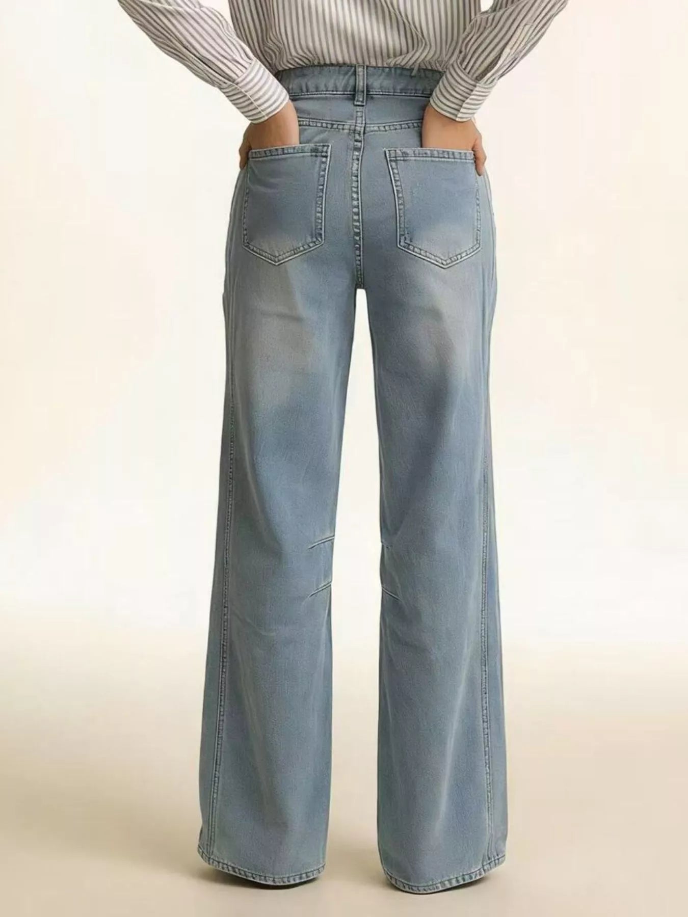 Wide Leg Wash Jeans featuring a buttoned pocketed design, shown from the back, highlighting the relaxed fit and light wash.