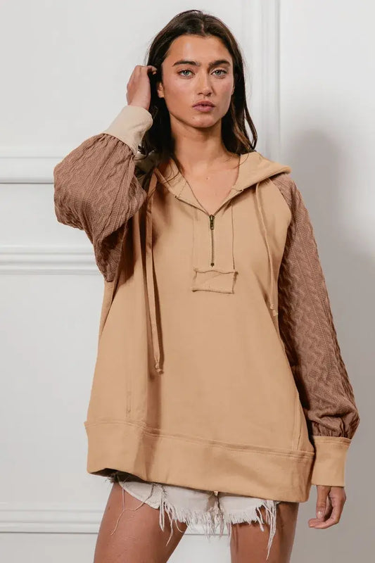 BiBi Half Zip French Terry Hoodie with Knit Sleeves in beige worn by a model, showcasing modern and stylish design.