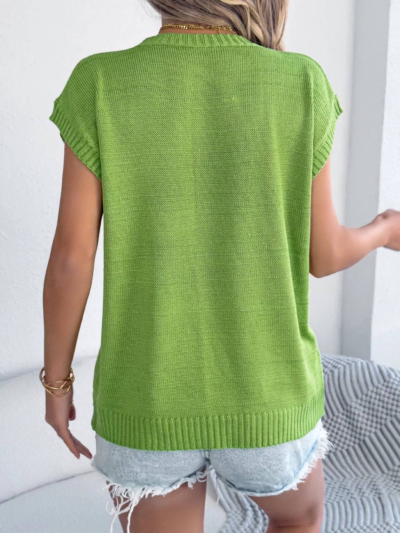 Back view of a stylish women's green Flower Round Neck Sweater highlighting the knitted texture and short sleeves.