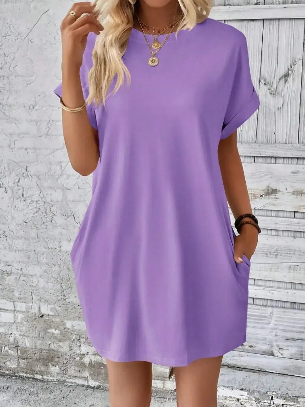 Pocketed round neck short sleeve dress in lavender with casual silhouette and practical pockets.