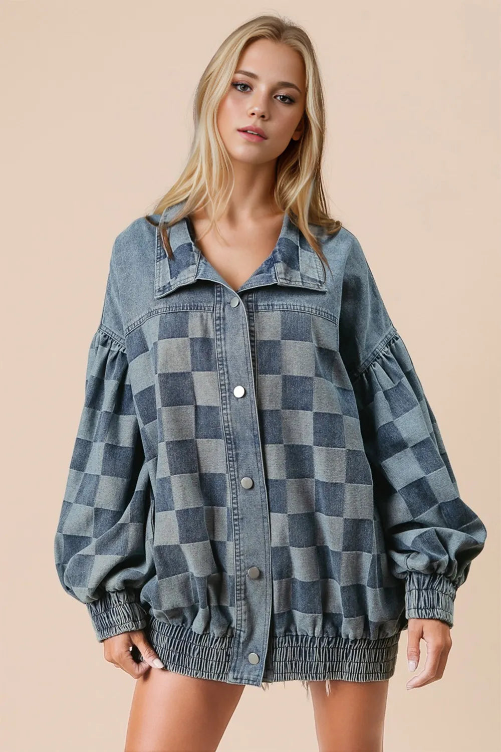 Model wearing a Double Take Checkered Button Up Denim Jacket in blue and gray, showcasing a casual style with oversized sleeves.