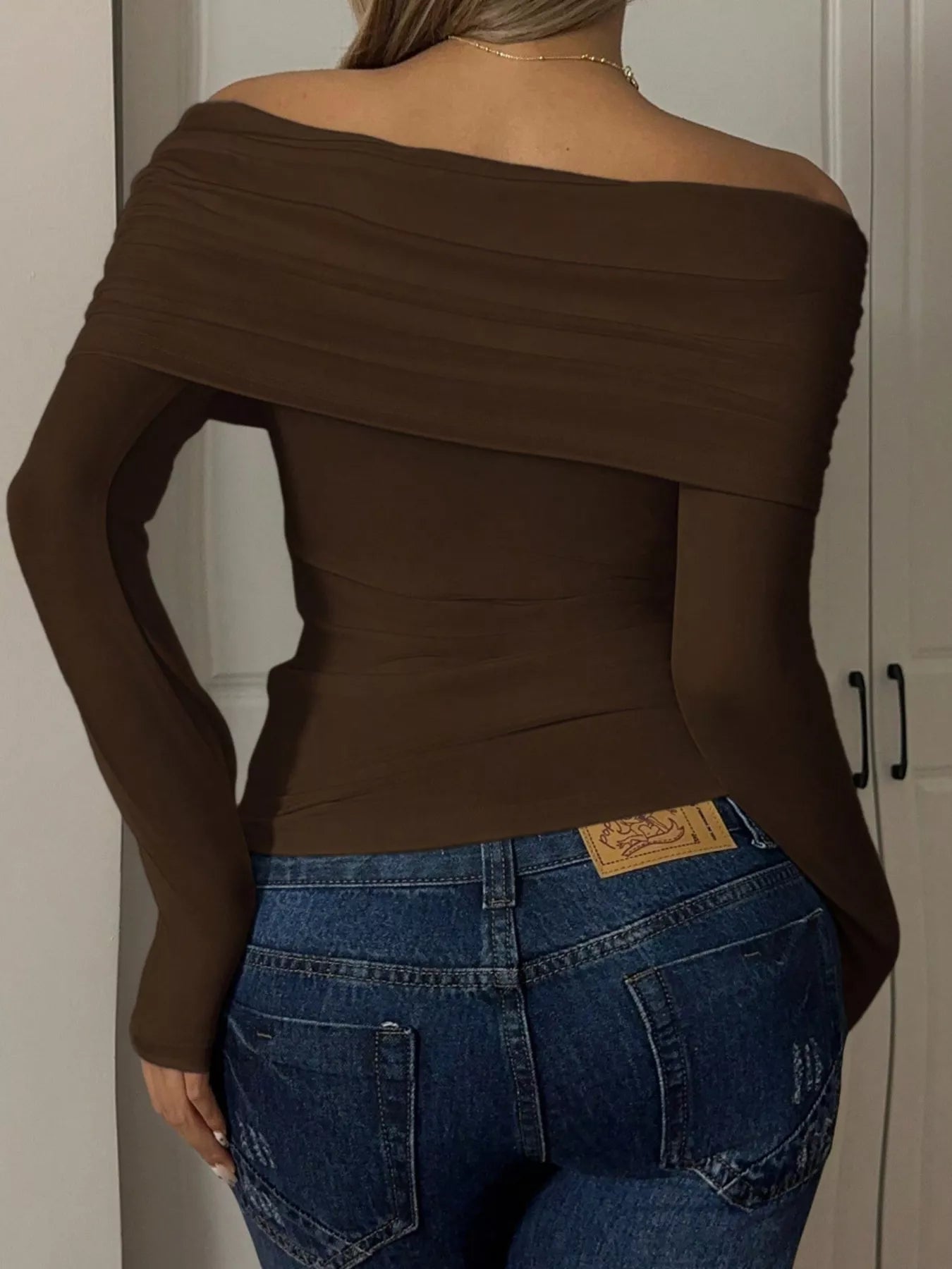 Woman wearing an Off-Shoulder Ruched Long Sleeve T-Shirt in brown from the back, showcasing the stylish design.
