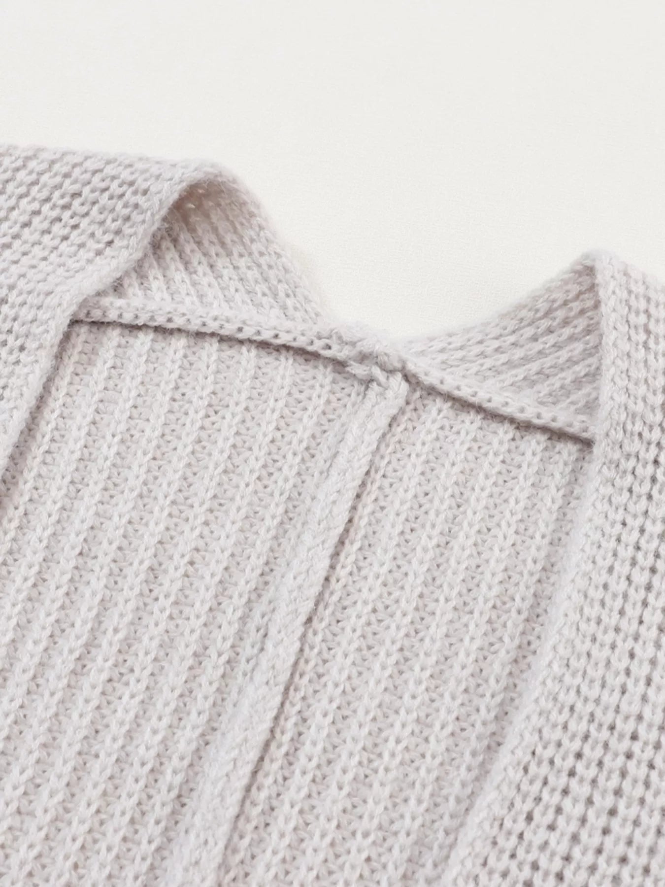 Back view of the Oversized Fold Over Sleeve Open Front Cardigan for Women, showcasing textured knit fabric.