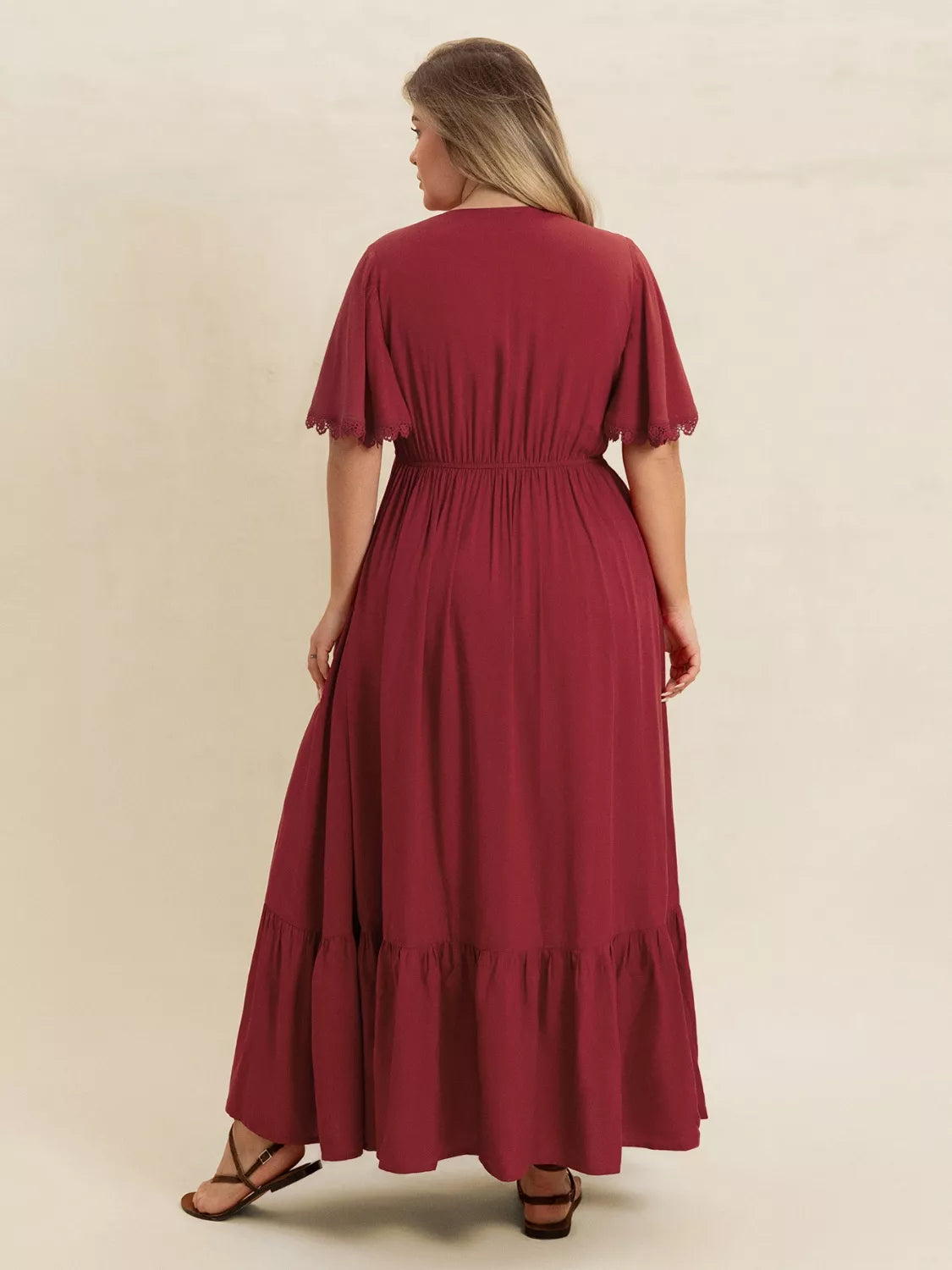 Back view of Plus Size Lace Detail Flutter Sleeve Maxi Dress in burgundy, showcasing flowing design and flutter sleeves.