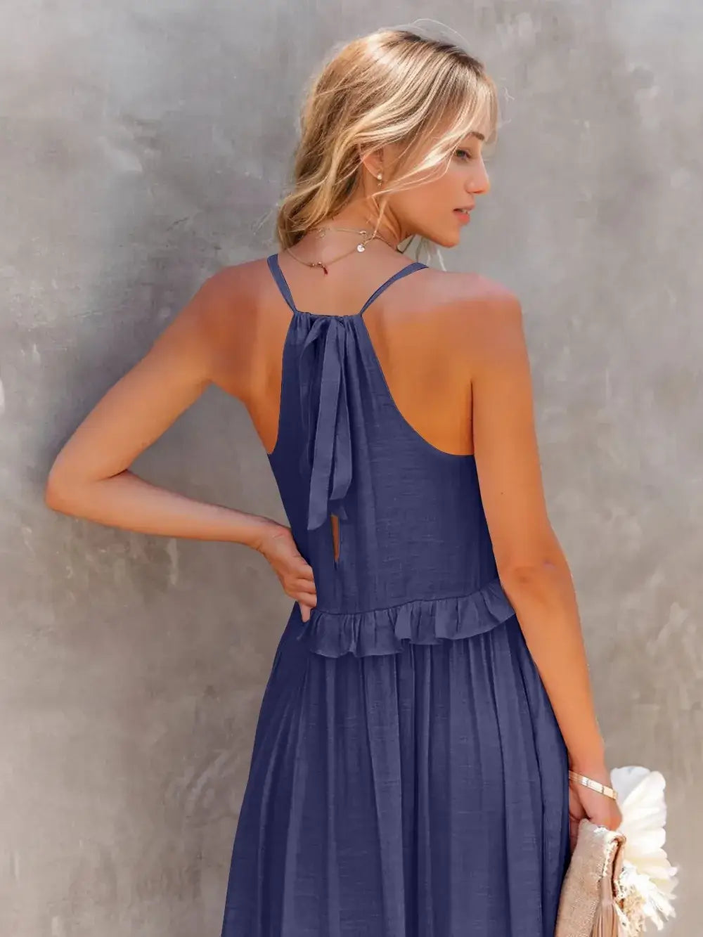 Ruffled Sleeveless Tiered Maxi Dress with Pockets showcased from the back, emphasizing ruffles and tie detail.
