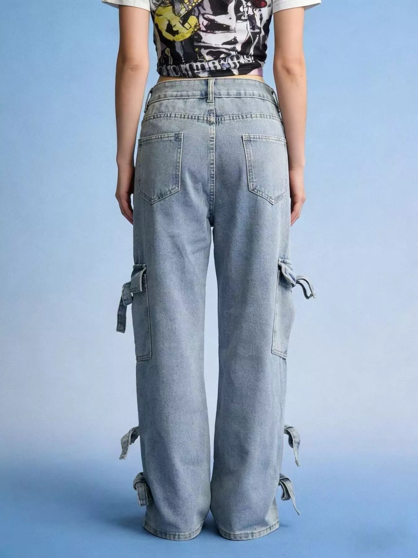 Woman wearing Bow Wide Leg Jeans with pocketed detail and relaxed fit, showcasing tied details on the sides.