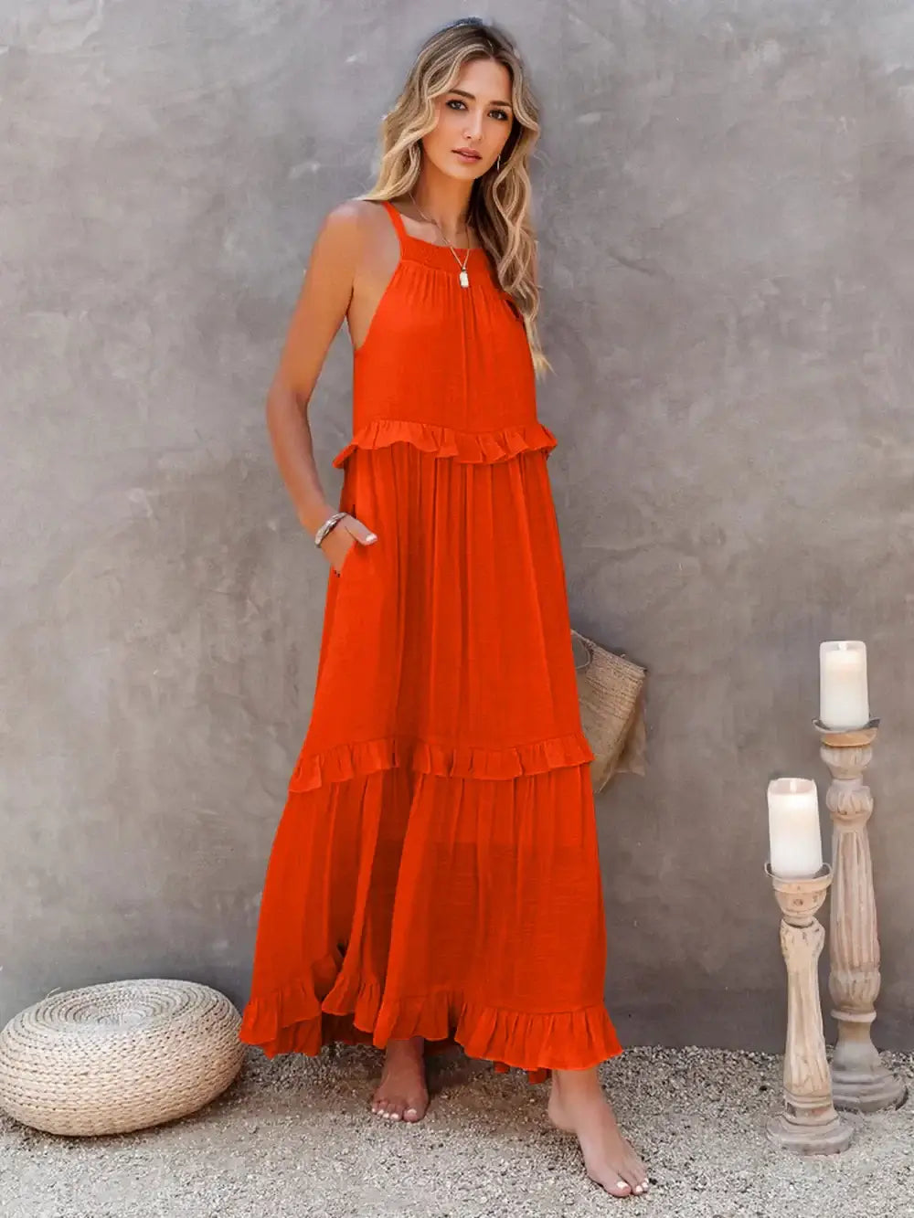 Ruffled Sleeveless Tiered Maxi Dress with Pockets in vibrant orange, showcasing soft ruffles and a flowing tiered silhouette.