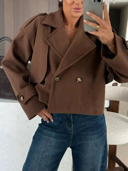 Double-Breasted Cropped Outerwear in brown, styled with jeans, featuring buttoned design and modern layered look.