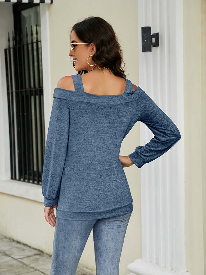 Back view of a woman wearing a Cold Shoulder Cutout Square Neck Blouse in blue, styled with jeans and sunglasses.
