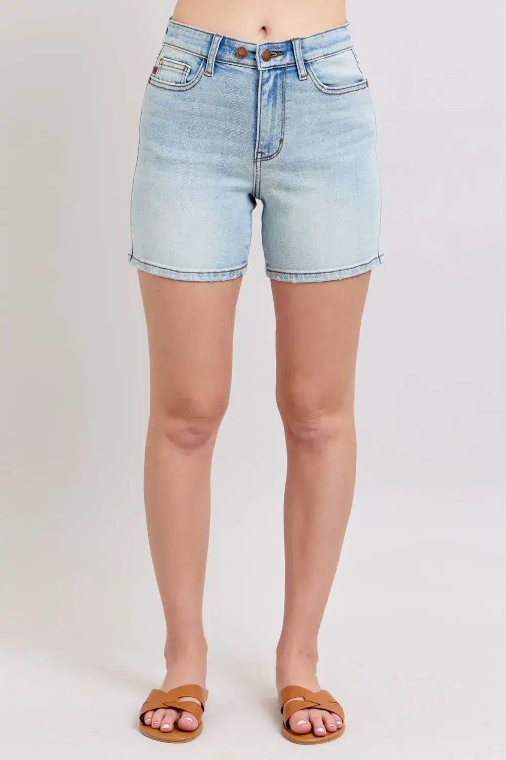 Light blue plus size Judy Blue denim shorts with two-button closure and pockets, perfect for casual summer wear.
