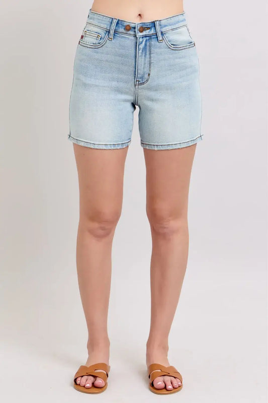 Light blue plus size Judy Blue denim shorts with two-button closure and pockets, perfect for casual summer wear.