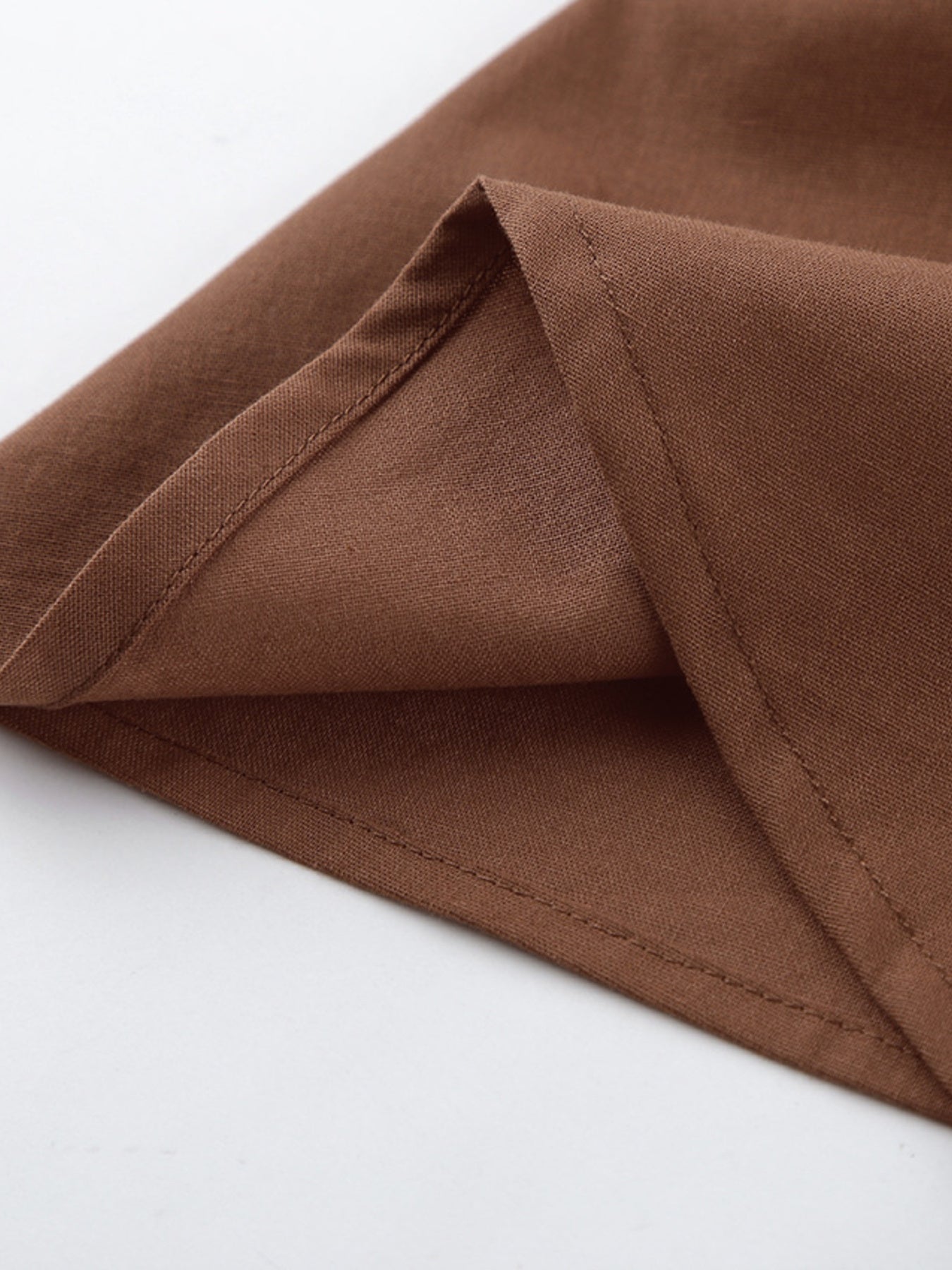 Close-up of the fabric detail showing the hem of the One Shoulder Top and Shorts Set stylish asymmetrical outfit.