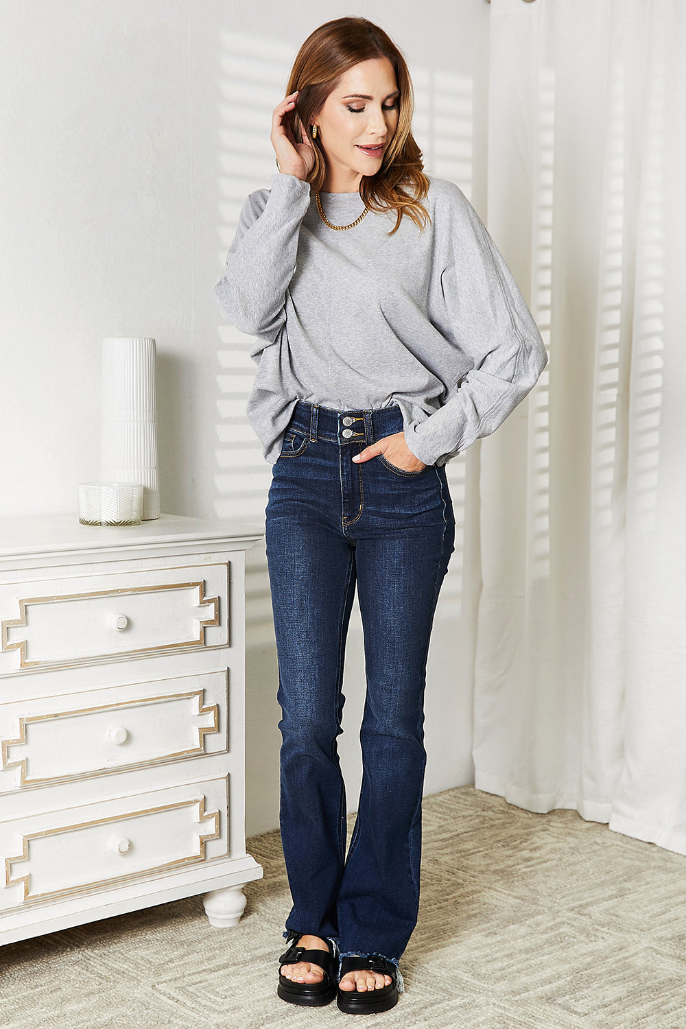 Double Take Seam Detail Round Neck Long Sleeve Top styled with flared jeans and casual sandals.