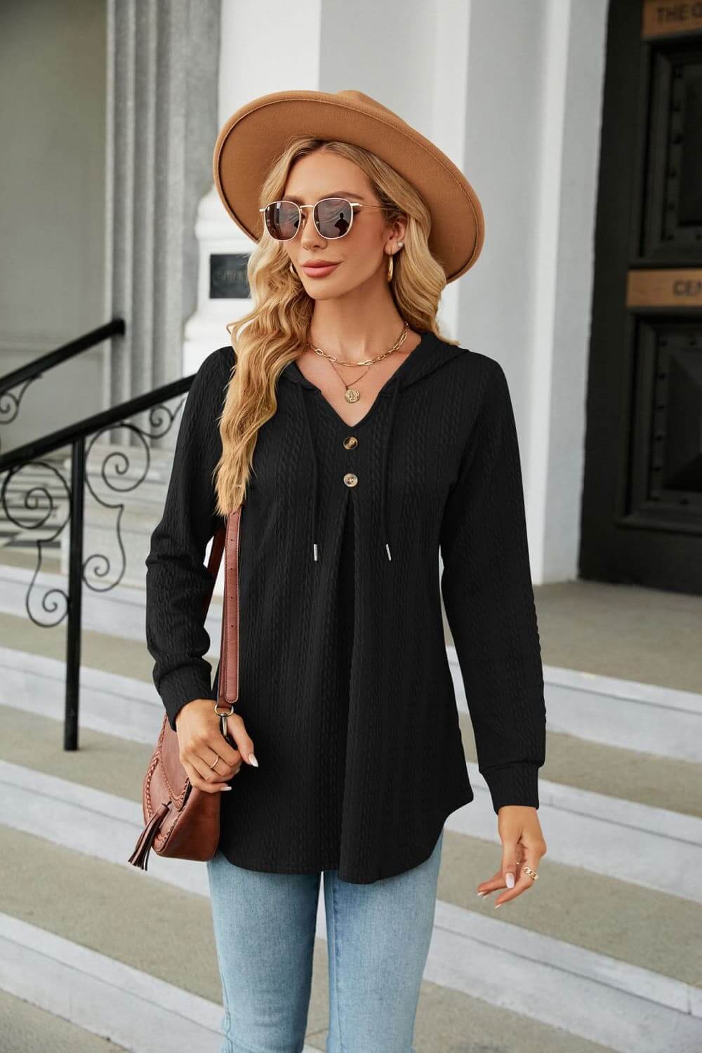 Model wearing Long Sleeve Hooded Blouse with adjustable drawstring hood and tie-neck, paired with sunglasses and a hat.