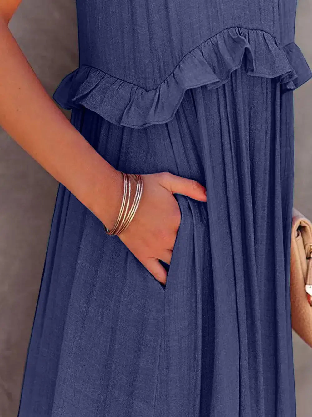 Ruffled Sleeveless Tiered Maxi Dress with Pockets showcasing pocket and ruffle detail.