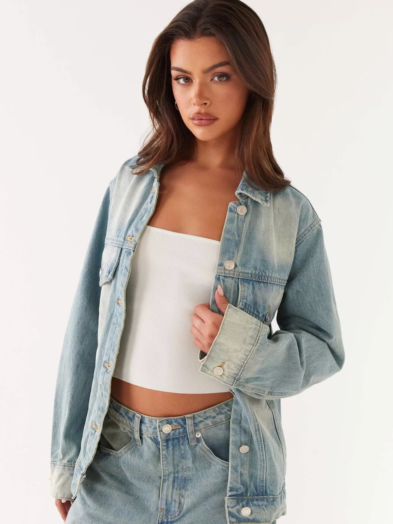 Button Up Denim Jacket and Jeans Set model wearing a stylish denim jacket with a white top.
