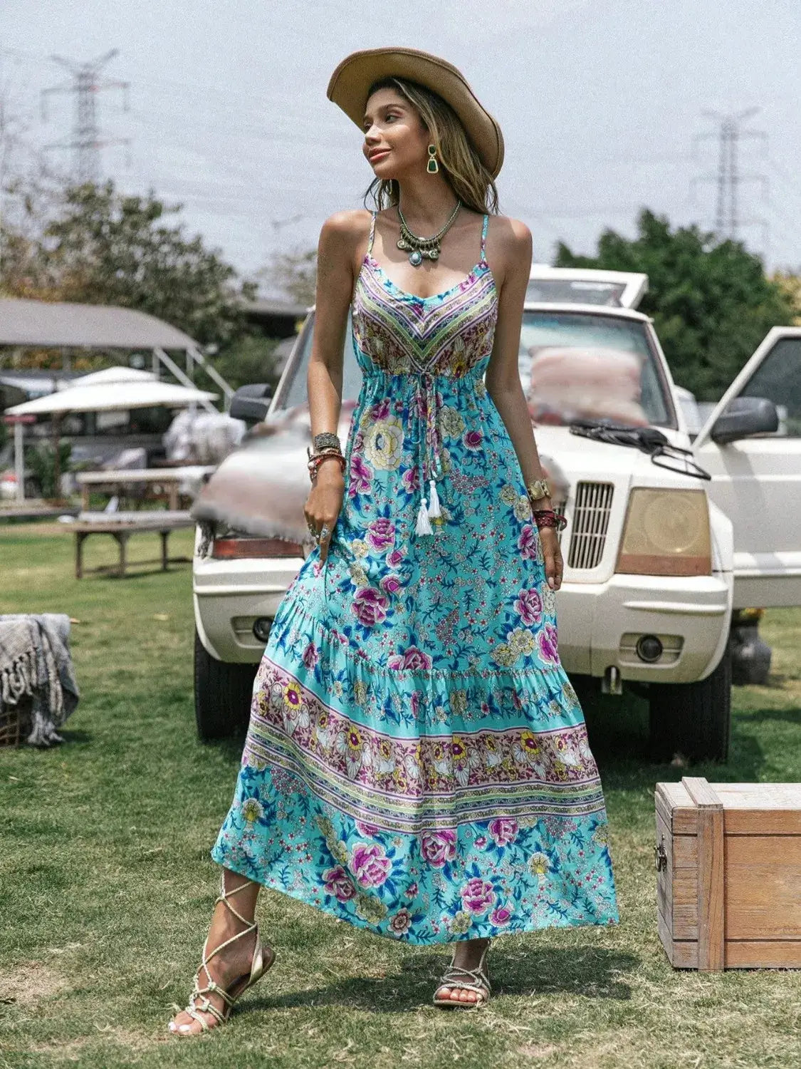 Tassel Floral Print Tiered Cami Dress worn by a woman outdoors, showcasing a vibrant floral design and bohemian style.