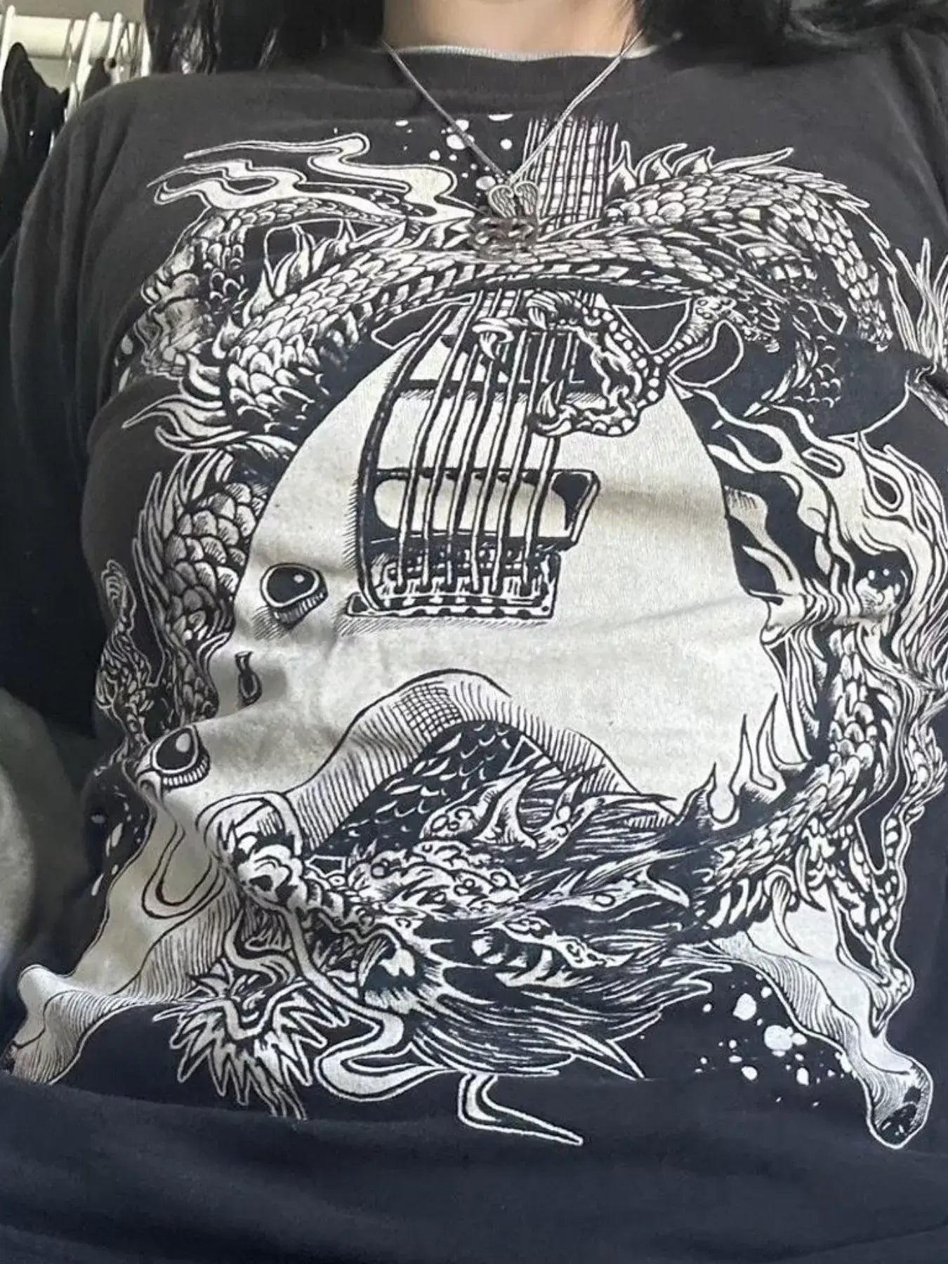Graphic round neck long sleeve t-shirt featuring intricate dragon and guitar design.