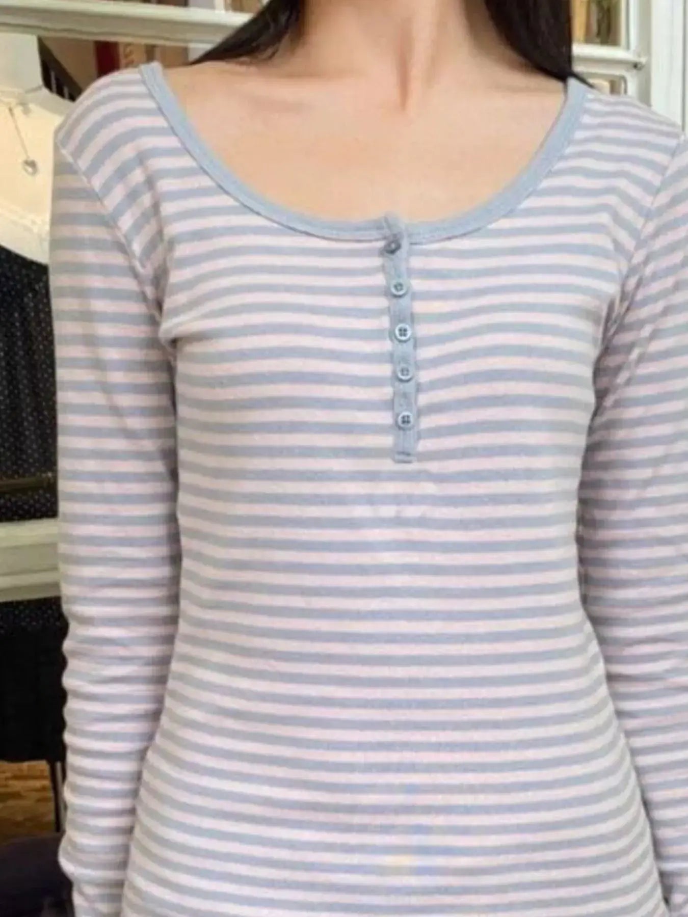 Striped long sleeve Henley t-shirt featuring button details and a soft round neck design.