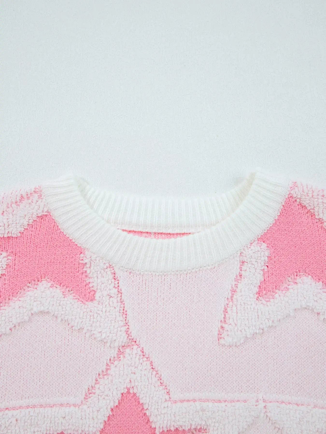 oversized star pattern ribbed edge drop shoulder sweater close-up showing the cozy knit and vibrant star design