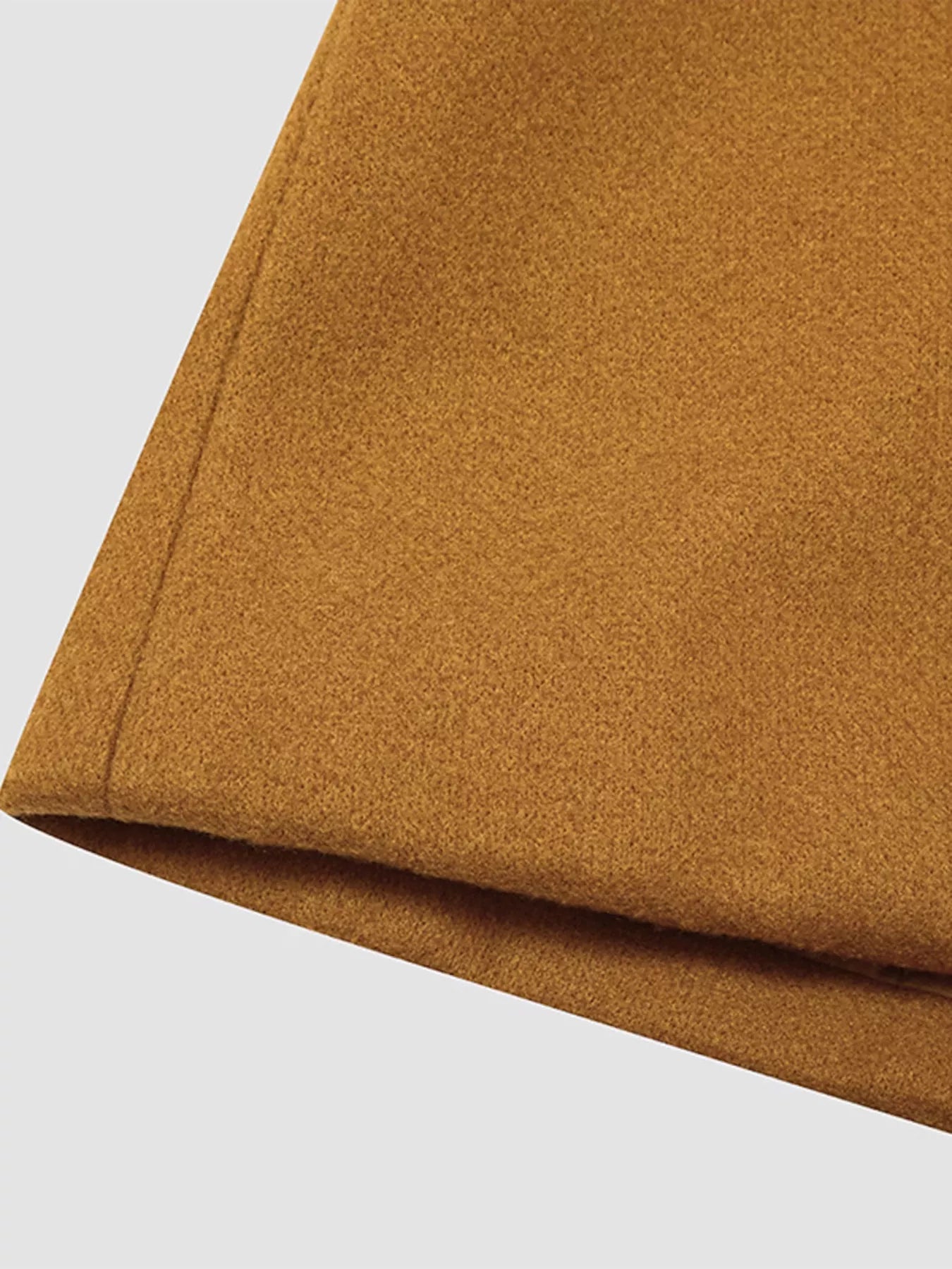 Close-up of the fabric of the Full Size Single Breasted Long Sleeve Overcoat for Women in a rich golden color.