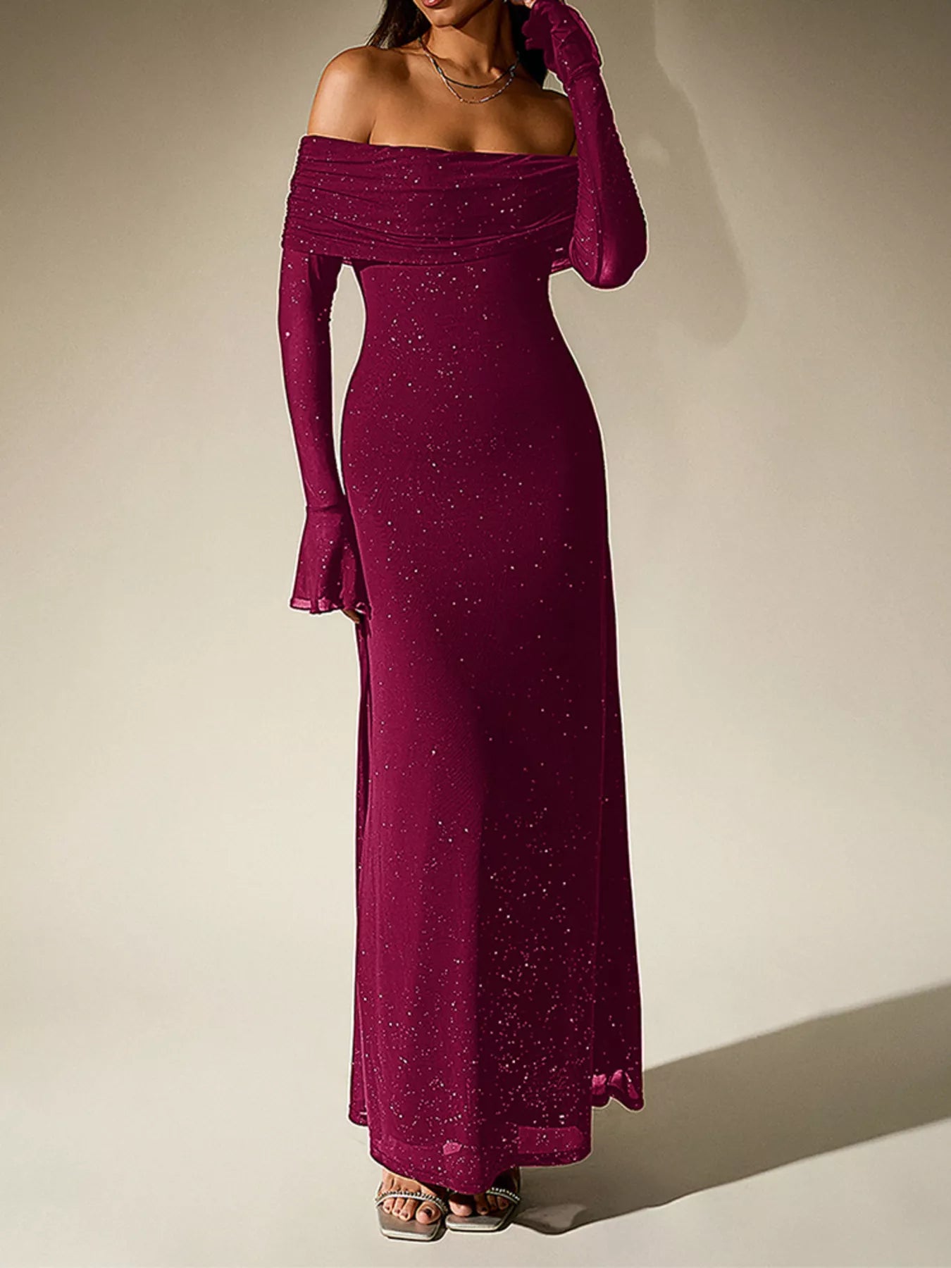 Glitter Off-Shoulder Maxi Dress displayed in deep burgundy color, featuring a form-fitting silhouette and glamorous glitter detailing.