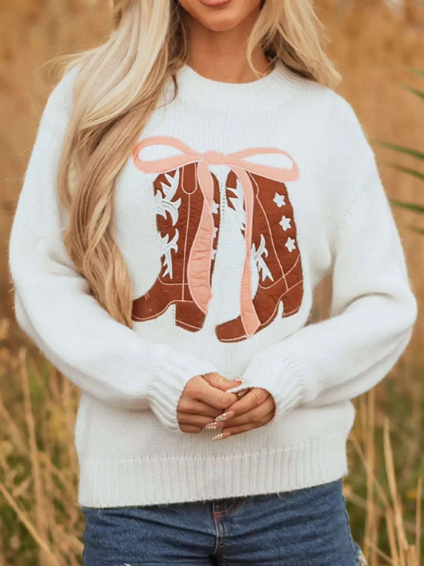Embroidered bow boots graphic drop shoulder sweater in white with playful cowboy boot design.