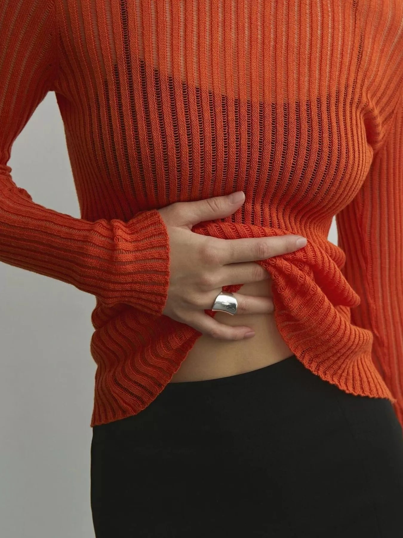 Ribbed Knit Long Sleeve Top in sheer orange hue, featuring slightly stretchy material and stylish ribbed design.