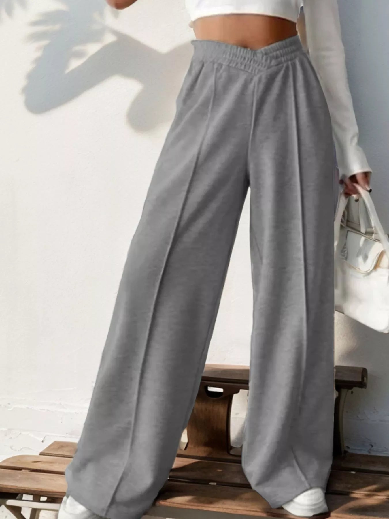 Wide Leg High Waist Pants in gray, styled for an elegant everyday look, paired with a white top and handbag.