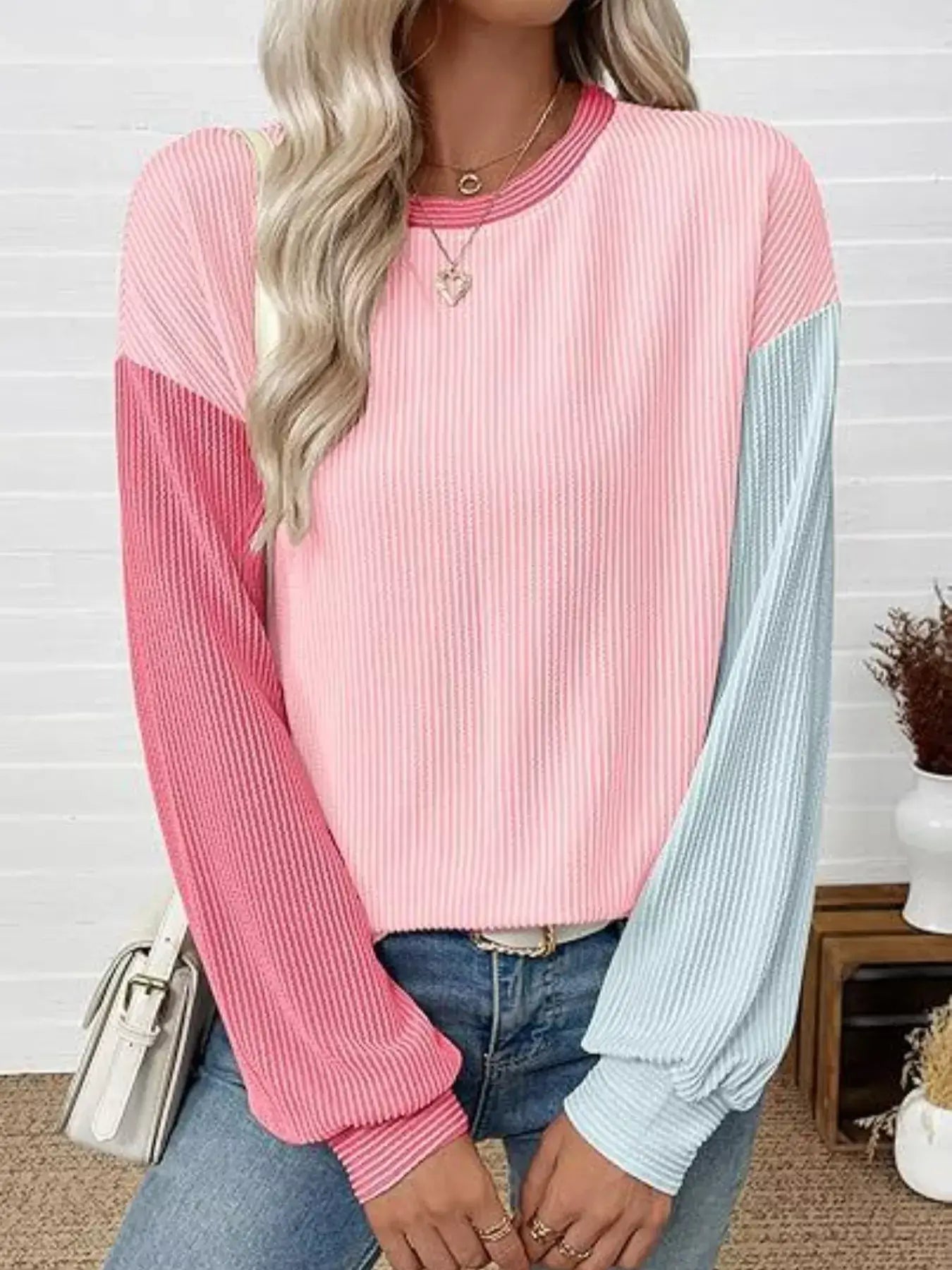Model wearing a Color Block Ribbed Long Sleeve T-Shirt in pink and blue, featuring a relaxed fit and casual style.
