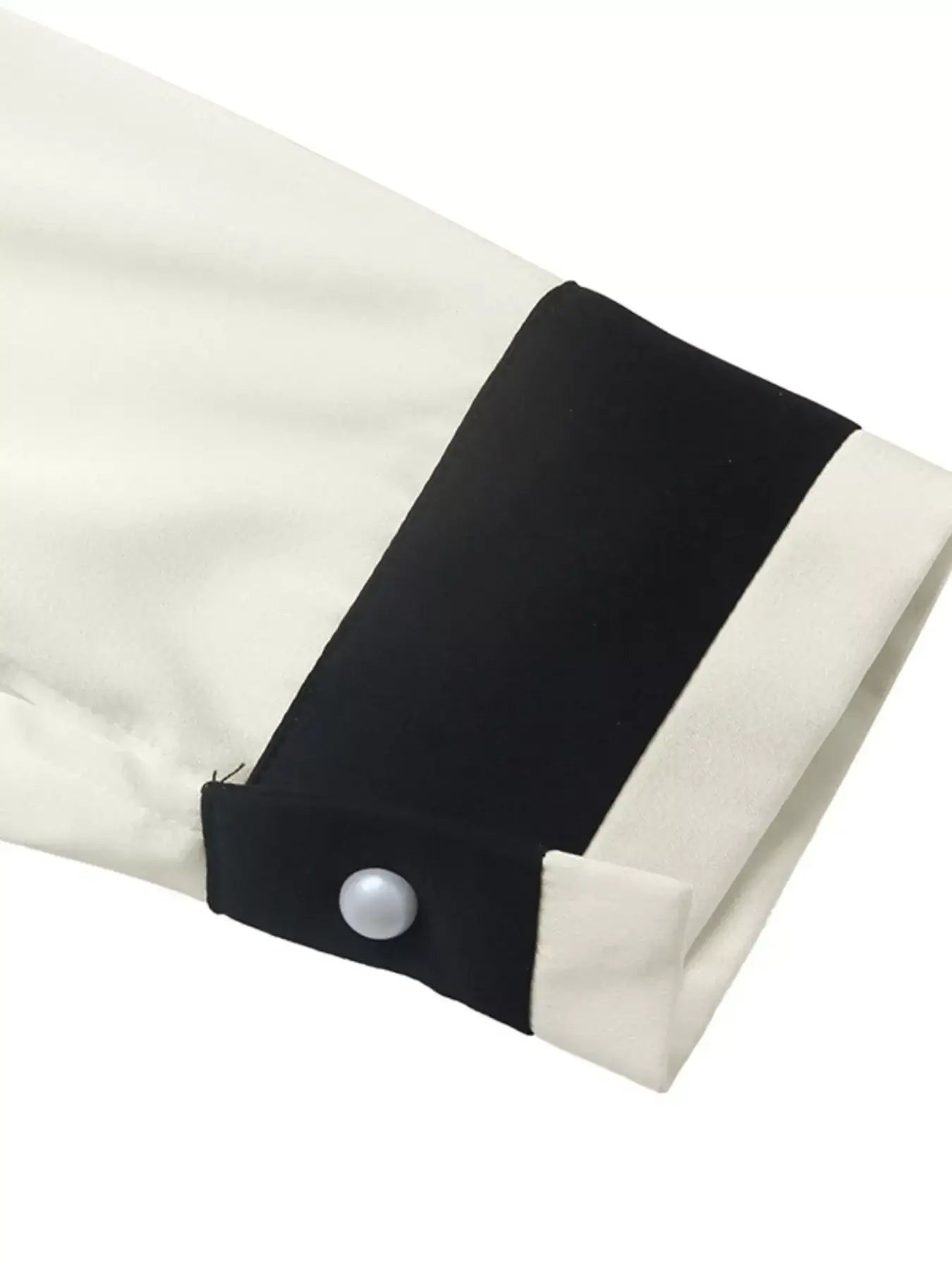 Close-up of the sleeve featuring contrast trim detail of Contrast Trim V-Neck Blouse in lightweight fabric.