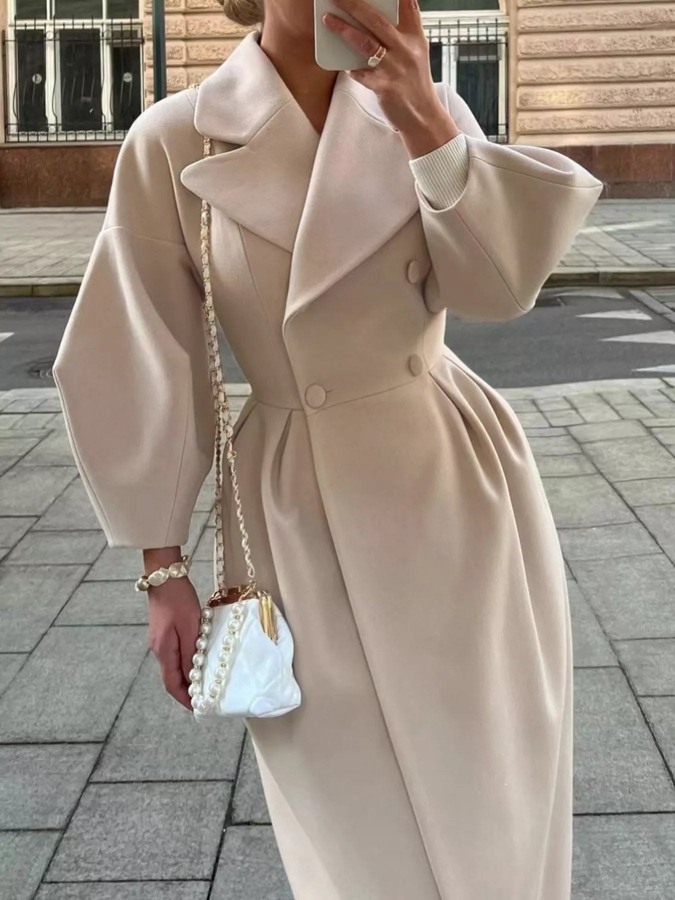 Double-Breasted Longline Coat worn outdoors, showcasing elegant tailored silhouette and chic accessories.