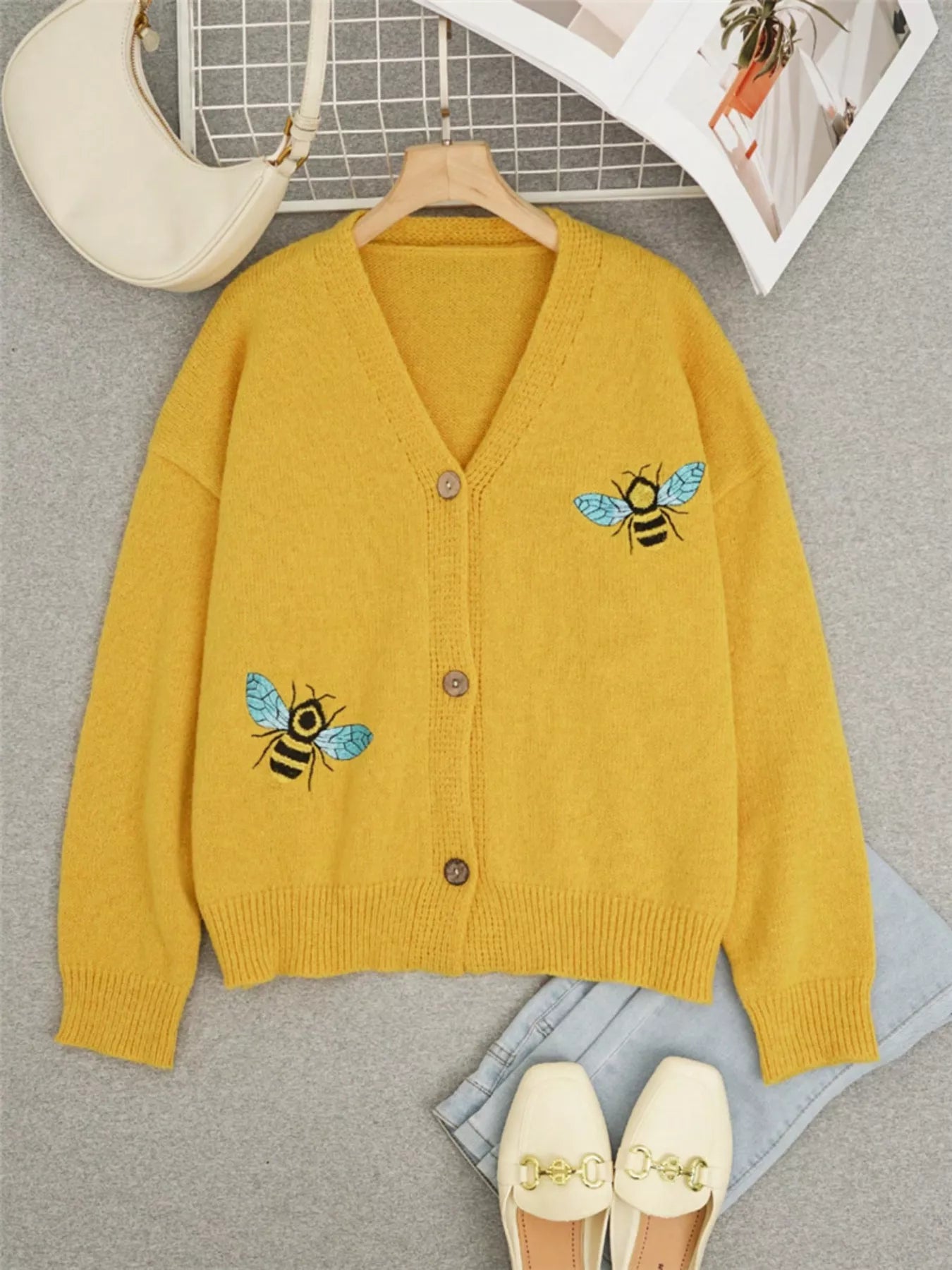 Bee Embroidered Button-Down Cardigan in yellow with blue bee embroidery on pockets, perfect for elegant everyday wear.
