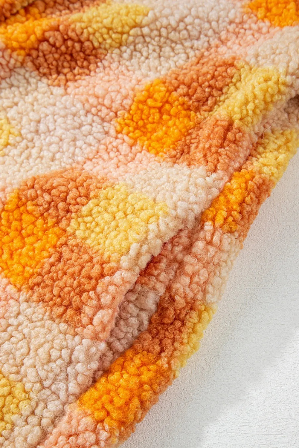 Checkered Long Sleeve Sherpa Hooded Jacket featuring a cozy, textured fabric in warm, vibrant colors.