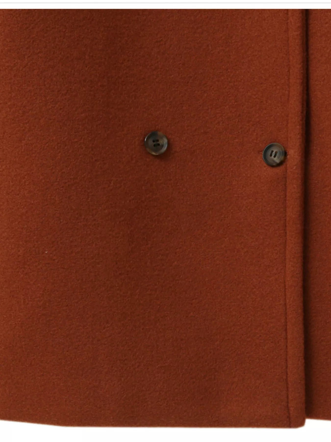 Close-up of the buttons on a Double-Breasted Long Sleeve Coat in a rich orange hue.