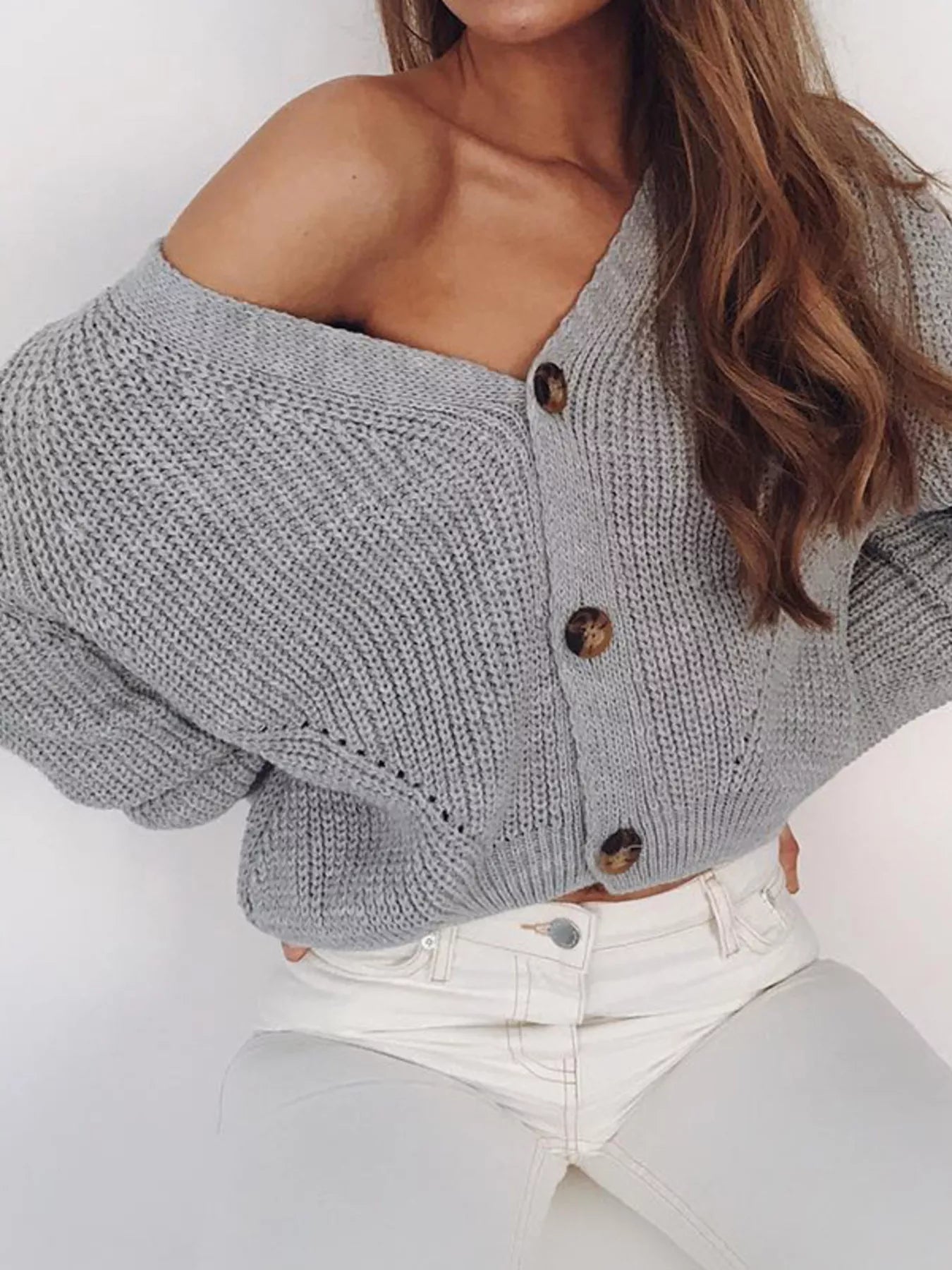 Model wearing a Chunky Knit Button Down Cardigan in gray, showcasing its cozy layered style and buttoned design.