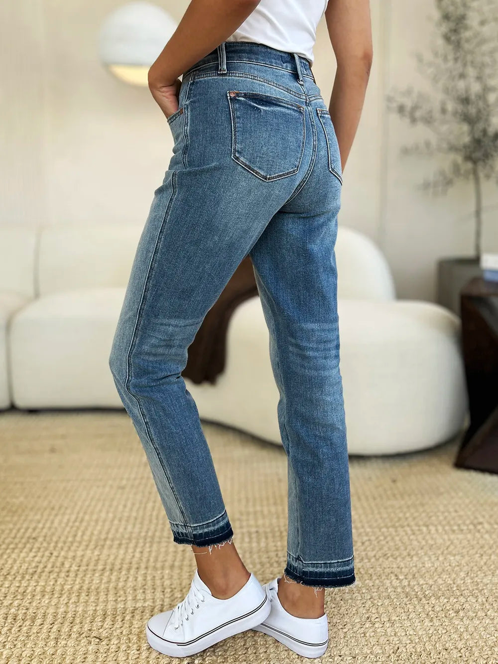 Mid Rise Magic Release Hem Jeans showcased from the back, featuring a structured fit and unique hem detail.
