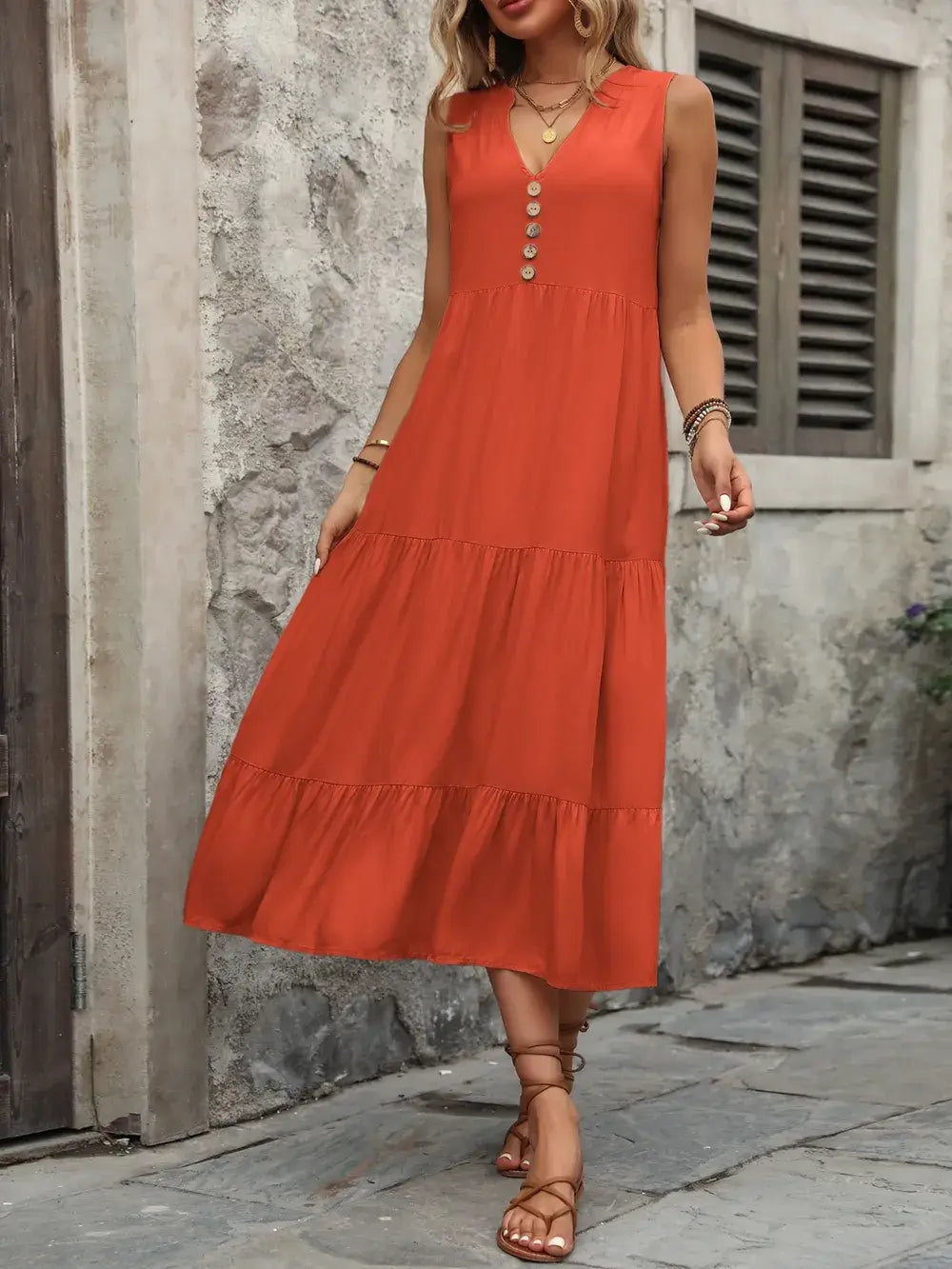 Ivy Lane Decorative Button Notched Sleeveless Dress in orange with decorative buttons and tiered skirt.
