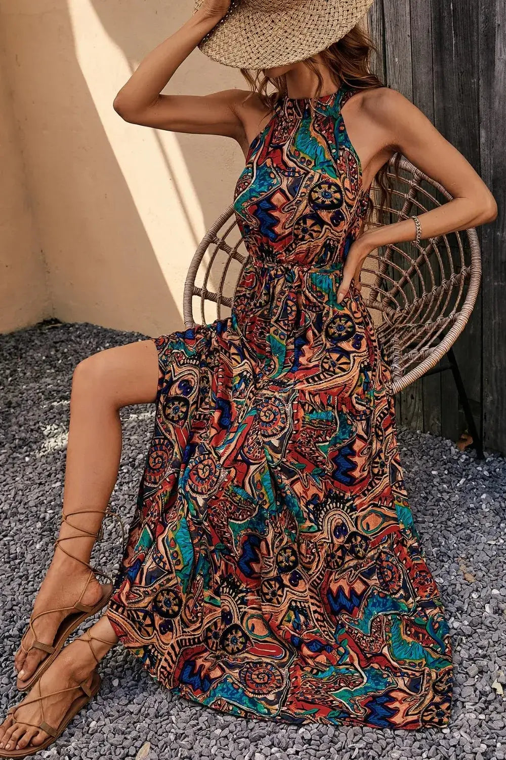 Model wearing a Tied Floral Sleeveless Dress in a colorful bohemian print, perfect for summer outings.