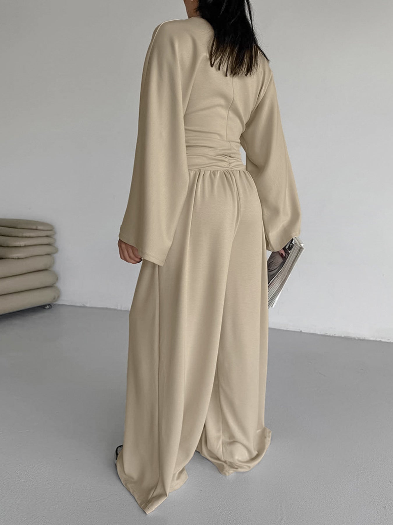 Back view of a model wearing a beige Round Neck Top and Wide Leg Pants Set showcasing its stylish design.