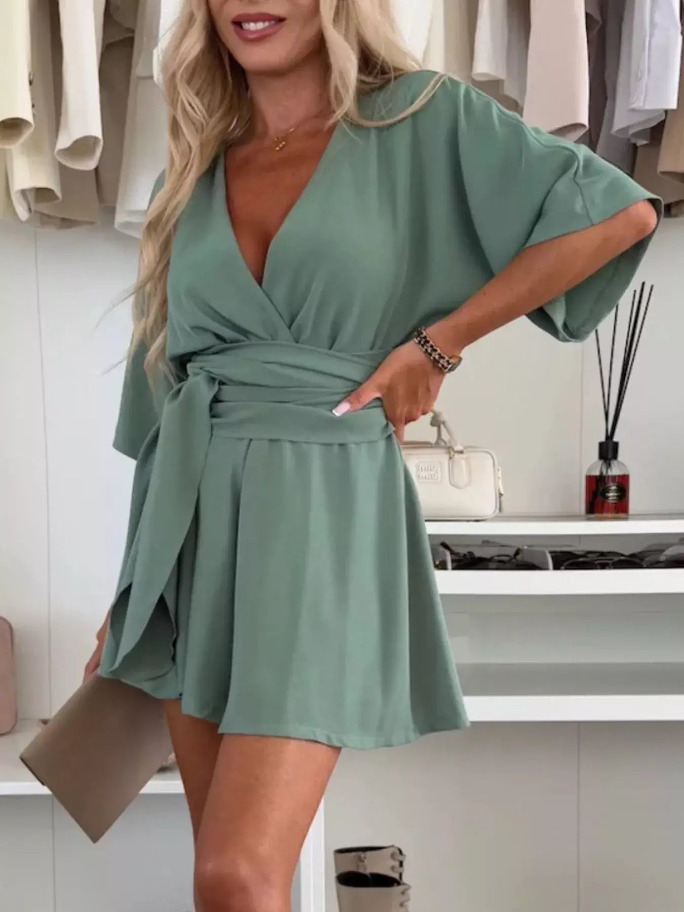 Full Size Surplice Tie Waist Romper modeled in green with a tie waist, short sleeves, and relaxed fit.