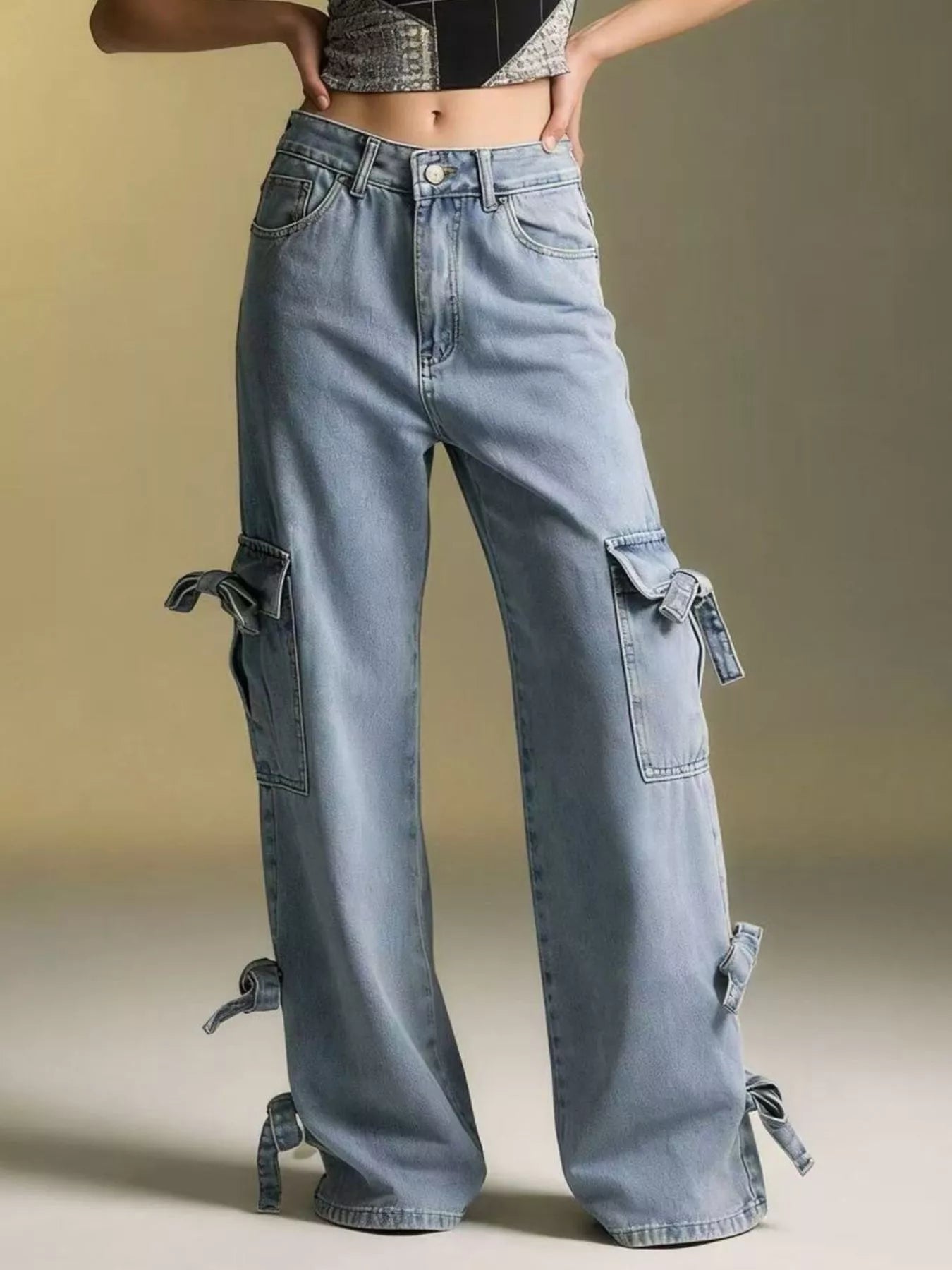 Bow Wide Leg Jeans with pocketed detail and relaxed fit, featuring unique bow ties and a light wash.