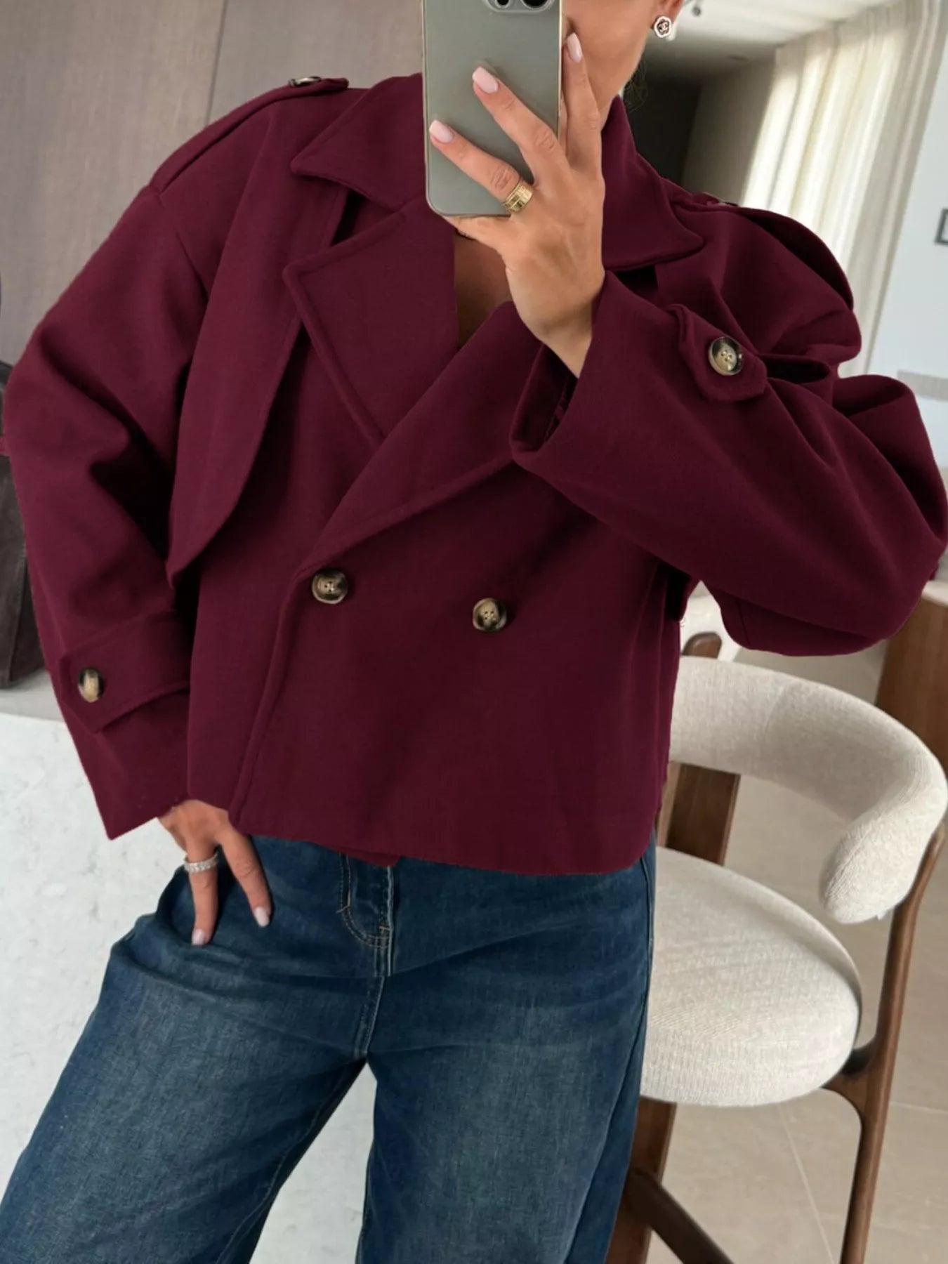 Double-Breasted Cropped Outerwear in burgundy, styled with jeans, perfect for modern layered looks.