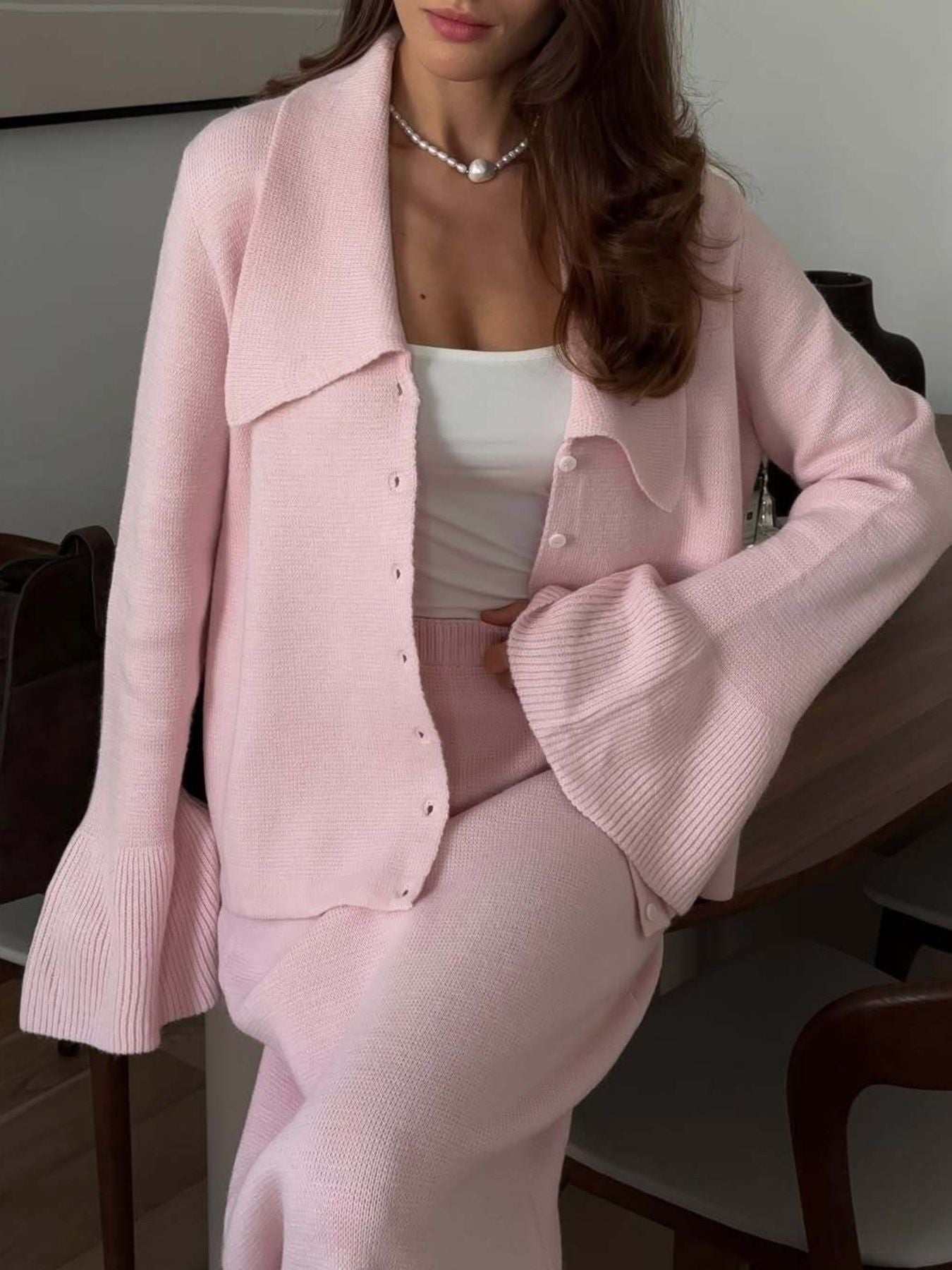 Button Down Cardigan and Skirt Knit Set in soft pink, featuring ribbed texture and stylish flared sleeves, perfect women's two-piece outfit.