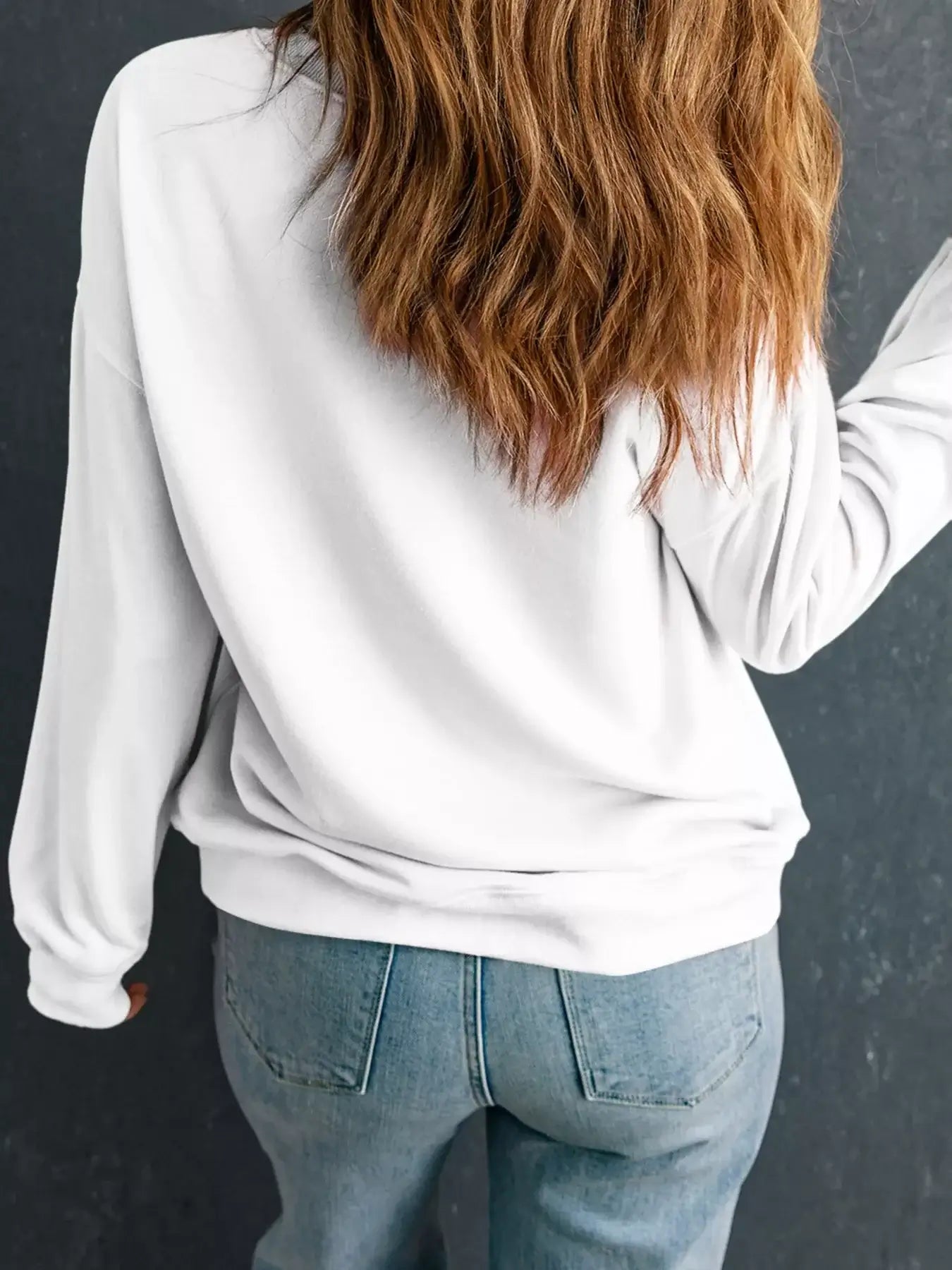 Back view of a woman wearing the Christmas Santa Rhinestone Drop Shoulder Sweatshirt with relaxed fit and casual style.