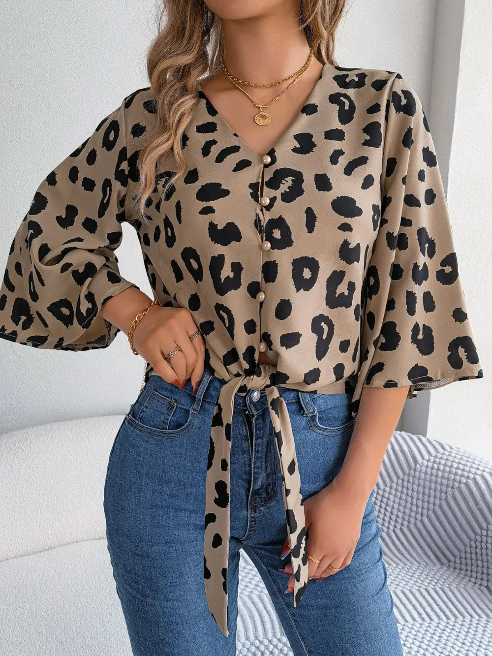 Tied Button Up Leopard V-Neck Blouse featuring a stylish tie, leopard print design, and bell sleeves.