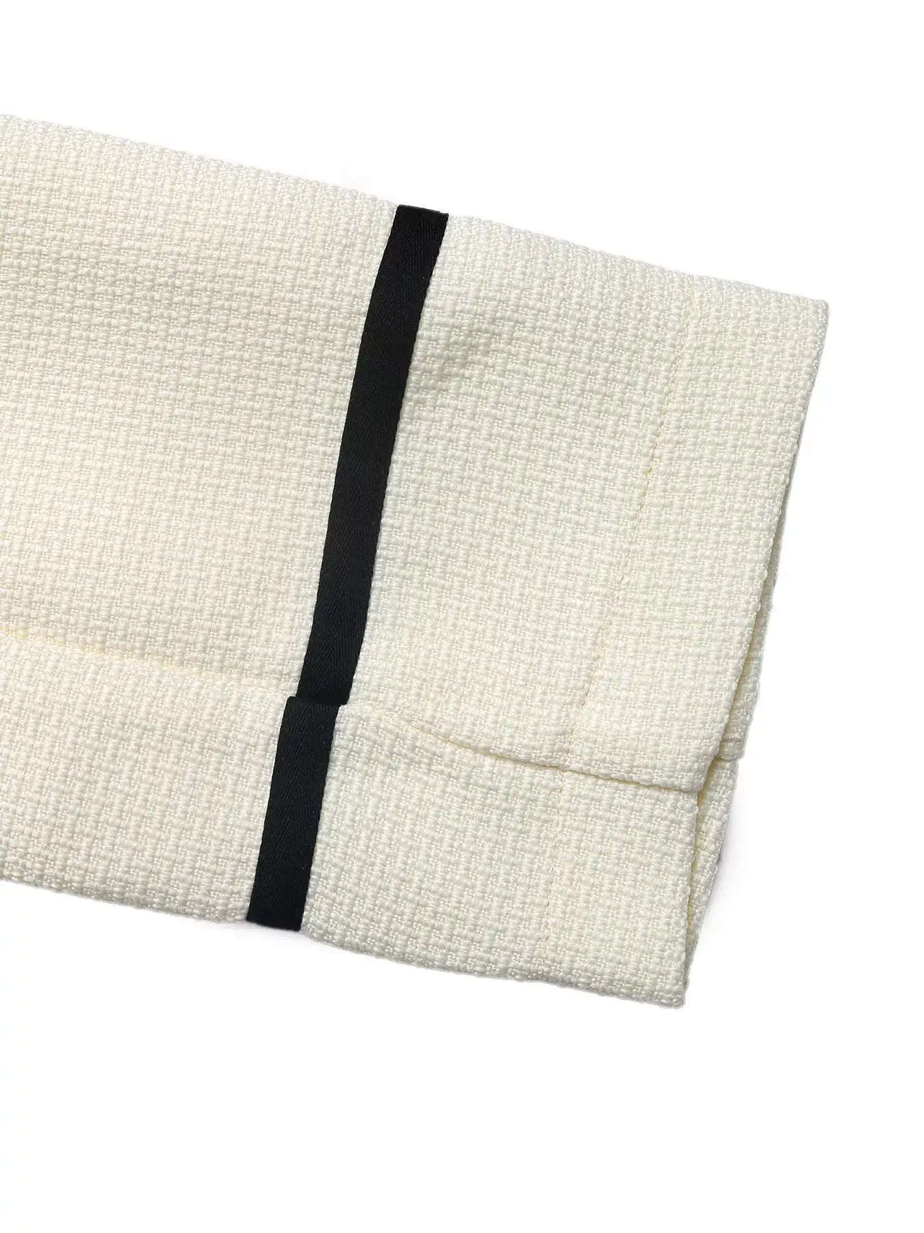 Contrast Trim Button-Up Blazer fabric detail showcasing elegant cream texture and stylish black contrast trim.