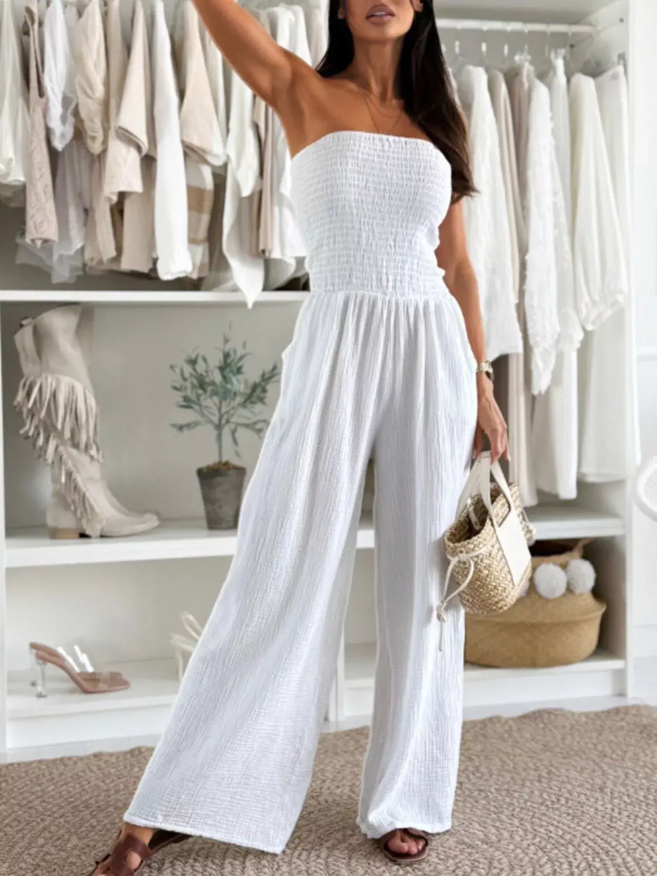 Model wearing a Smocked Tube Wide-Leg Jumpsuit in white, showcasing a strapless design with a flowy wide-leg fit.