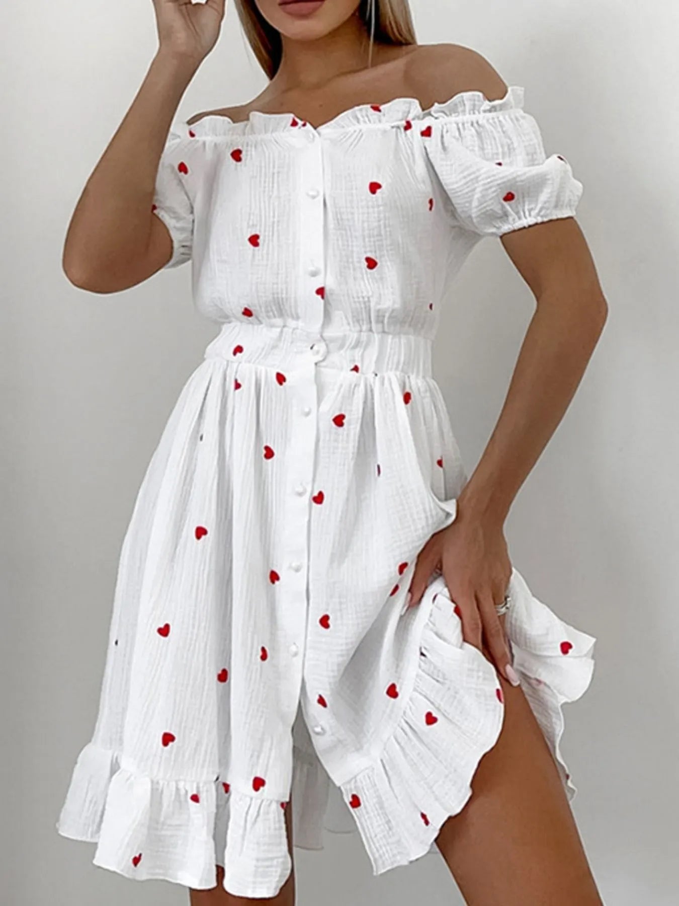 Heart Printed Off-Shoulder Ruffle Mini Dress featuring red hearts, frills, and buttoned front design.