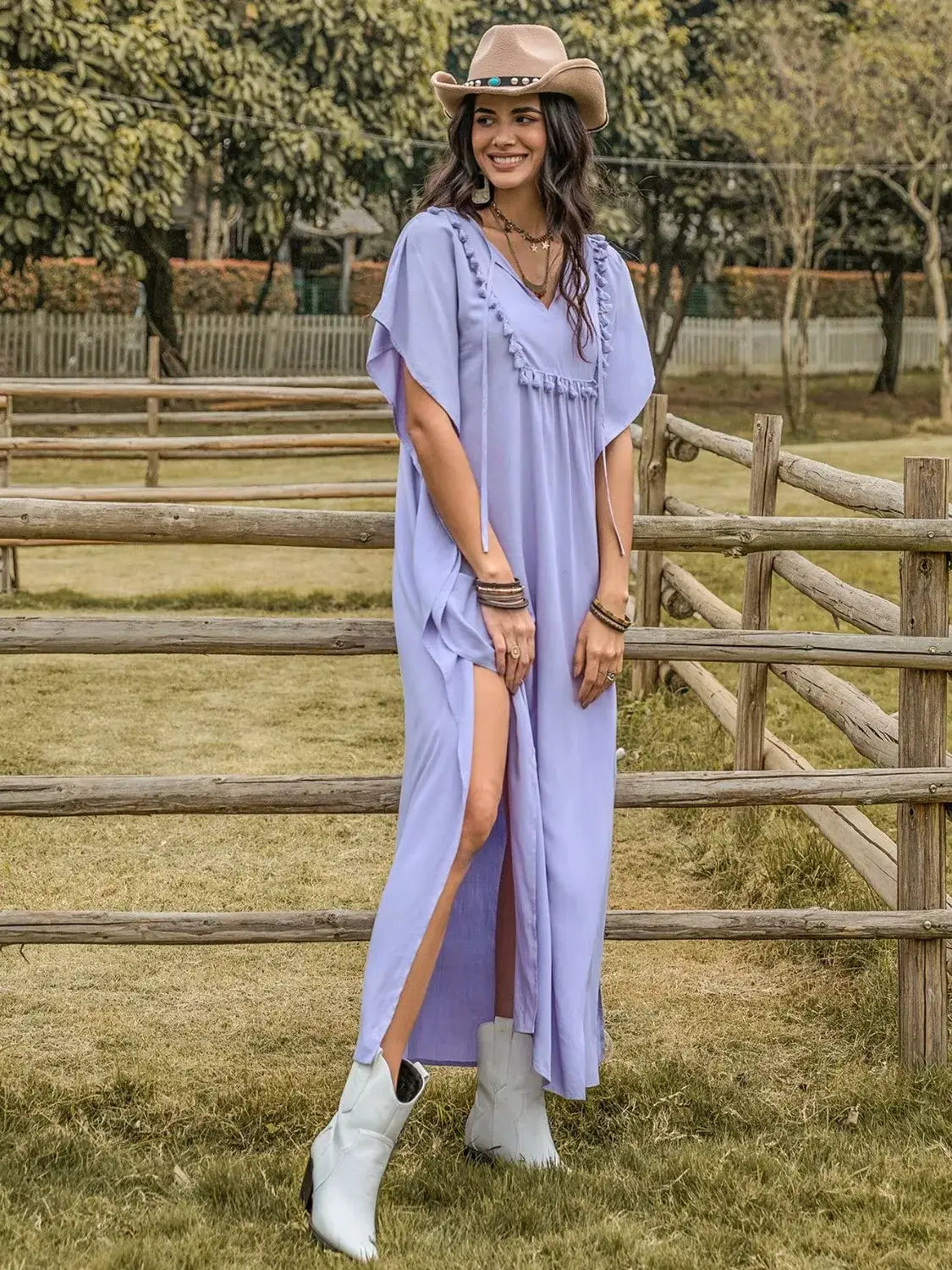 Side Slit Tie Neck Flutter Sleeve Dress modeled outdoors, showcasing flutter sleeves and a side slit for elegant occasions.